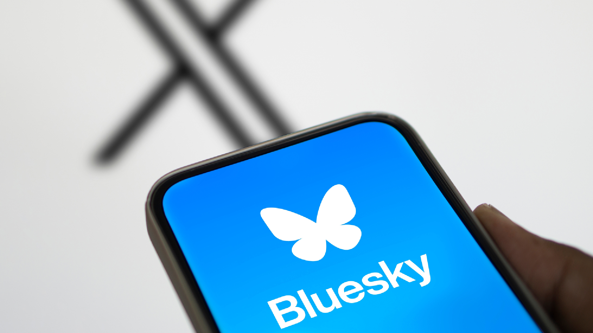 Bluesky logo with X logo in the background