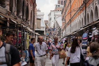 Tourists walk down a street