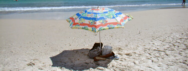 Beachgoers planting umbrellas on the beach