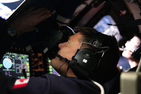Astronauts capturing images through the windows of the Orion spacecraft