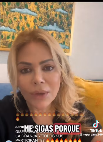 Close-up of Gisela Valcárcel, blonde woman, speaking to the camera. He wears dark clothes, background with yellow and green abstract painting. There are superimposed texts and the TikTok logo