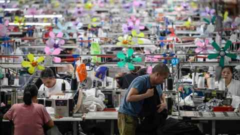 Trabajadores que producen prendas en una fábrica textil que suministra ropa a la empresa de comercio electrónico de moda rápida Shein en Guangzhou