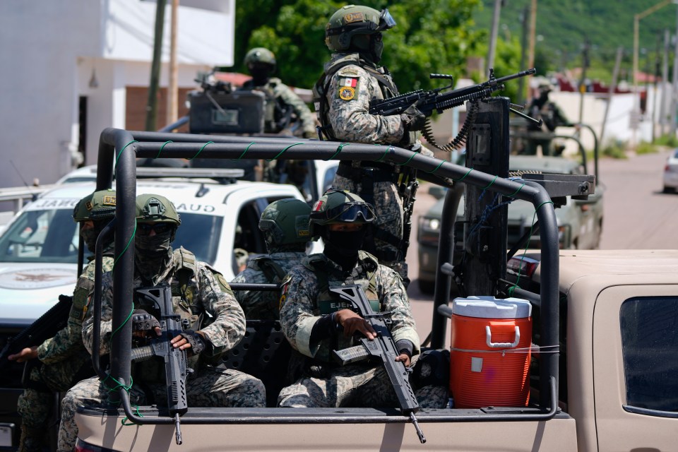 Guardias Nacionales y fuerzas del Ejército patrullan las calles durante un operativo en un barrio de Culiacán, estado de Sinaloa.