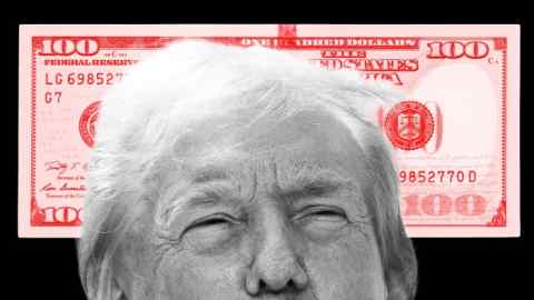 La parte superior de la cabeza de Donald Trump frente a un enorme billete rojo de 100 dólares.