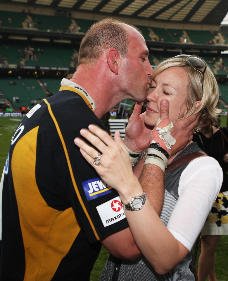 Lawrence Dallaglio de las avispas de Londres besa a su esposa después de una victoria en el partido de rugby.