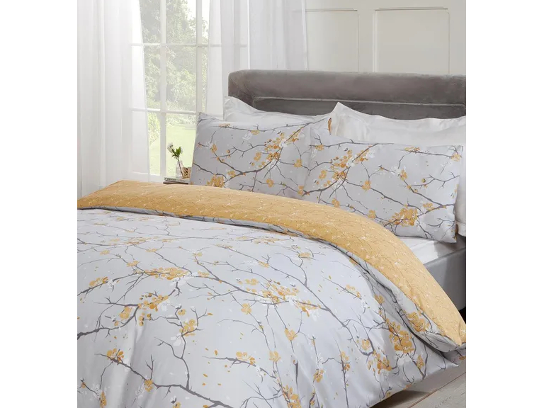 Cubierta nórdica y fundas de almohadas con estampado de flor gris y amarillo.