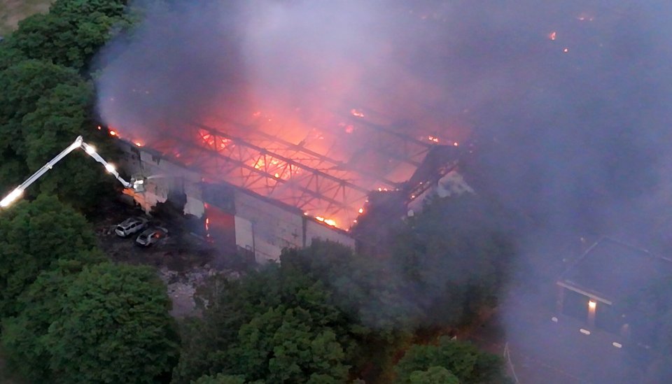 Vista aérea de un gran edificio envuelto en llamas.