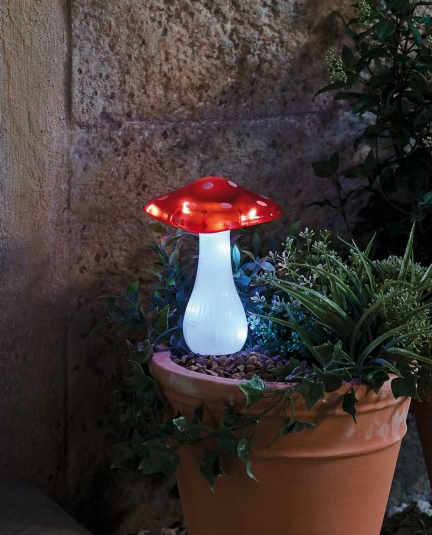 Luz de estaca de hongos con energía solar en una olla de terracota.