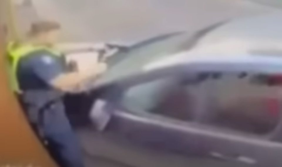 Imagen borrosa de un oficial de policía en un automóvil.