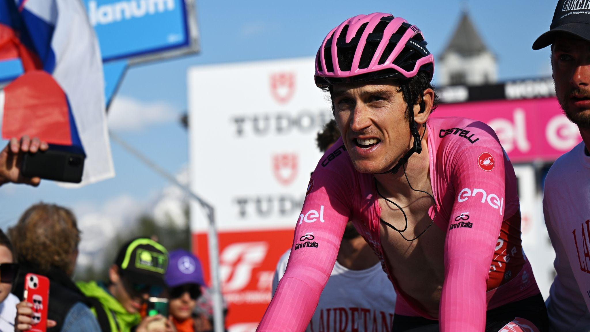 Geraint Thomas in the pink leader's jersey is disappointed crossing the finish line on the penultimate stage in the 2023 Giro d'Italia having seen Primoz Roglic snatch overall victory