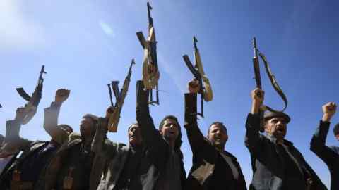 Les membres des tribus fidèles aux Houthis brandissent des armes