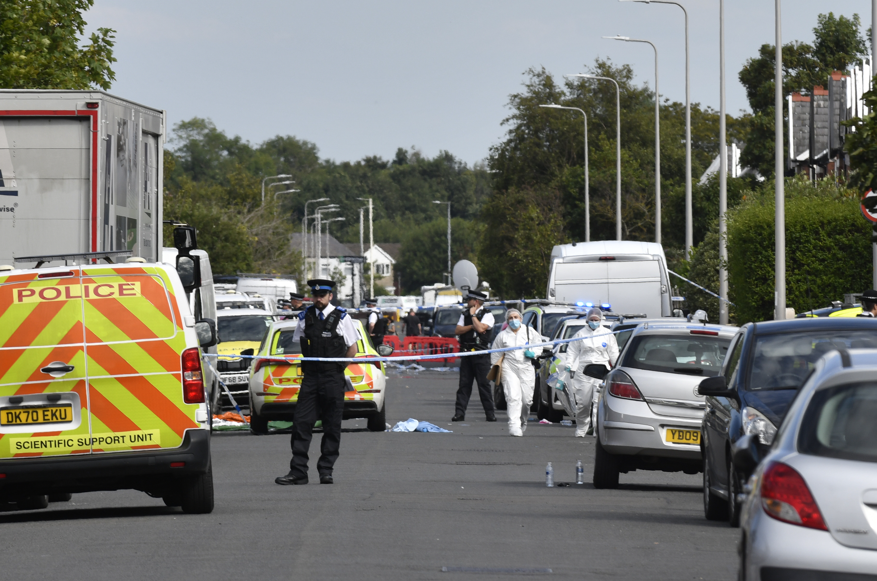 Des policiers et des agents de la police scientifique à l'intérieur du cordon lundi