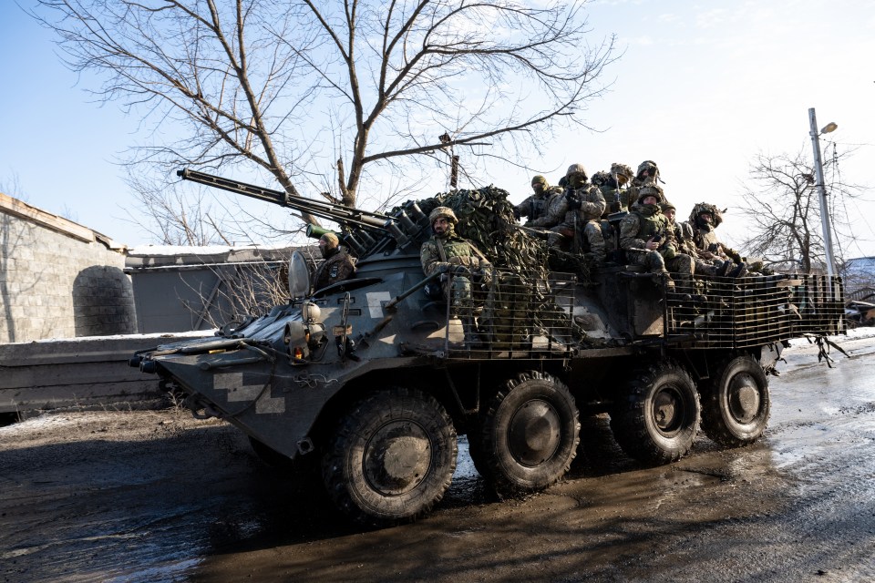 Des soldats ukrainiens se rendent à bord d'un véhicule blindé dans le village de Torske, sur la ligne de front de la région du Donbass