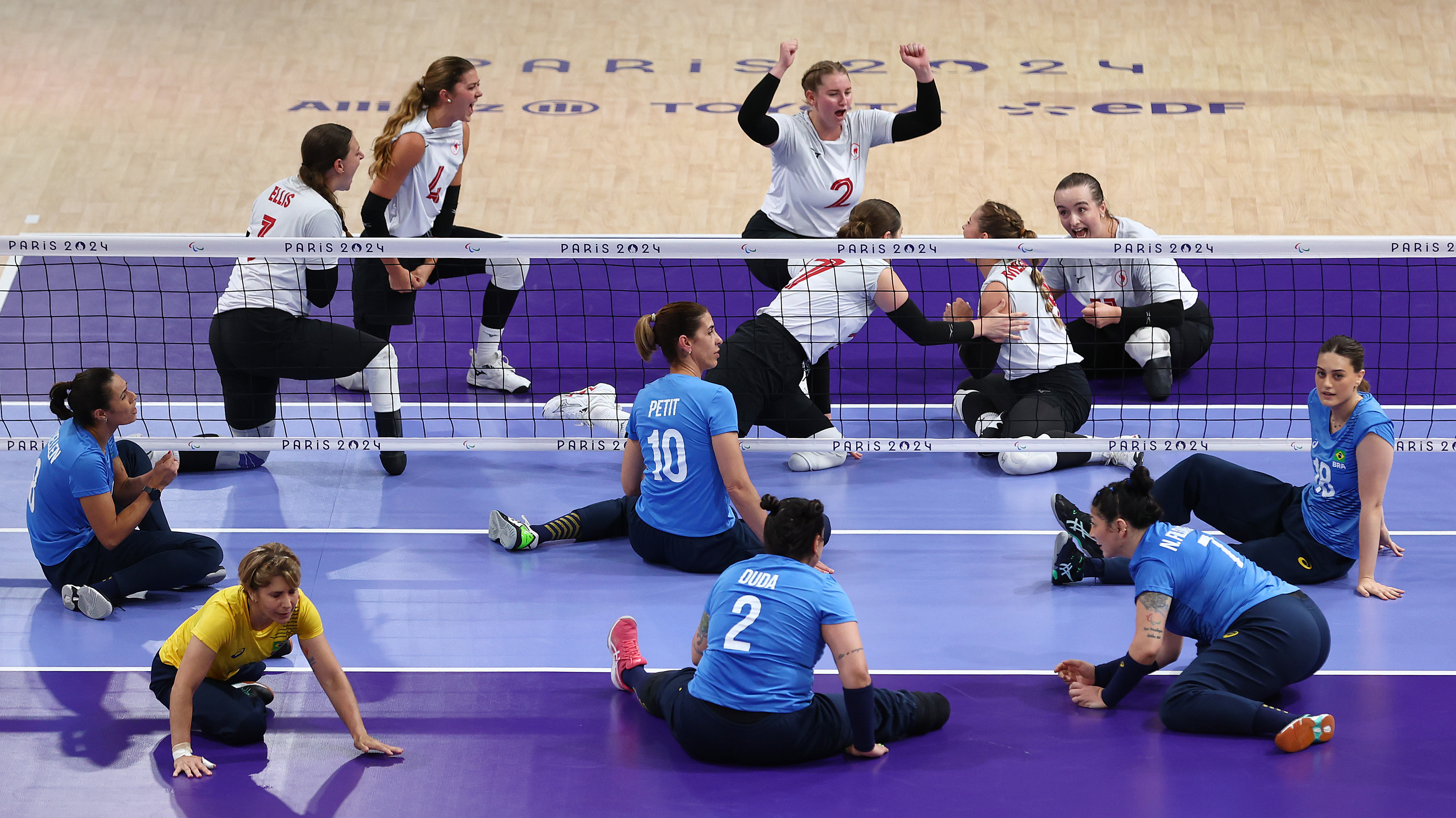 Les joueurs de volleyball assis du Canada applaudissent.