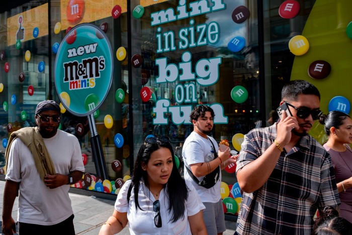 Touristes et visiteurs nationaux dans le West End à Leicester Square, à l'extérieur du magasin M&Ms à Londres 