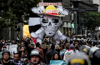 Protesters hold up a figure