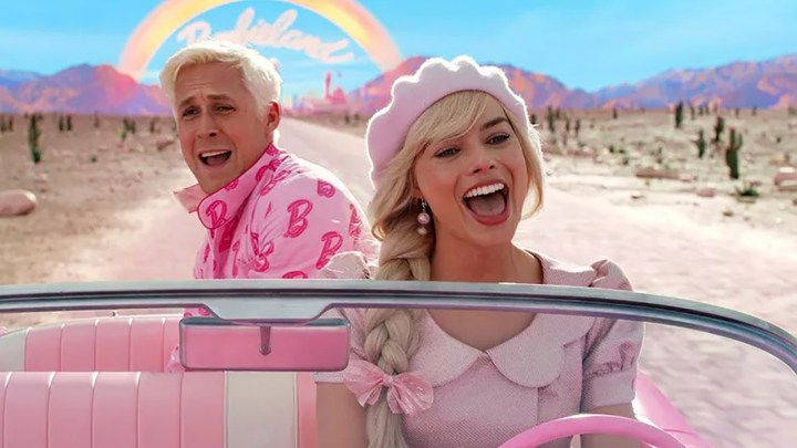 Barbie and Ken singing and driving in a pink car in a scene from Barbie.