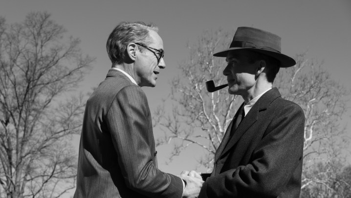 Robert Downey Jr. and Cillian Murphy as Lewis Strauss and Robert J. Oppenheimer shaking hands in black-and-white in Oppenheimer.