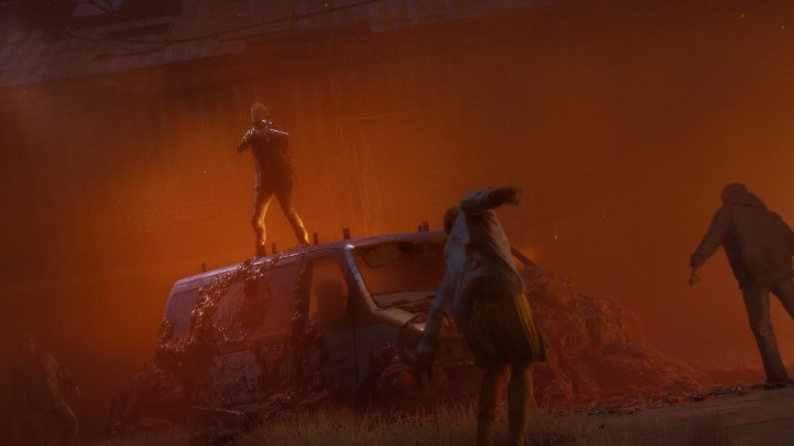 Hayatta kalanlardan biri bir minibüsün tepesinden zombi kalabalığına ateş ediyor.