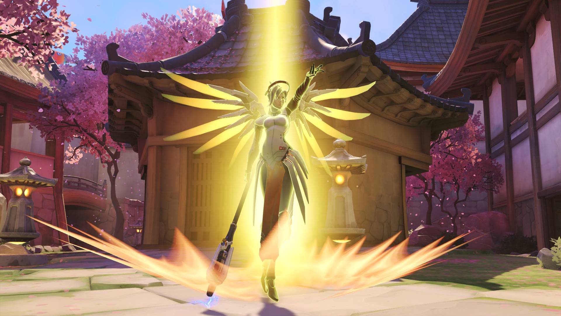 Overwatch'tan Mercy, kiraz çiçekleriyle çerçevelenmiş bir pagoda evinin önünde bir diriliş büyüsü yapıyor