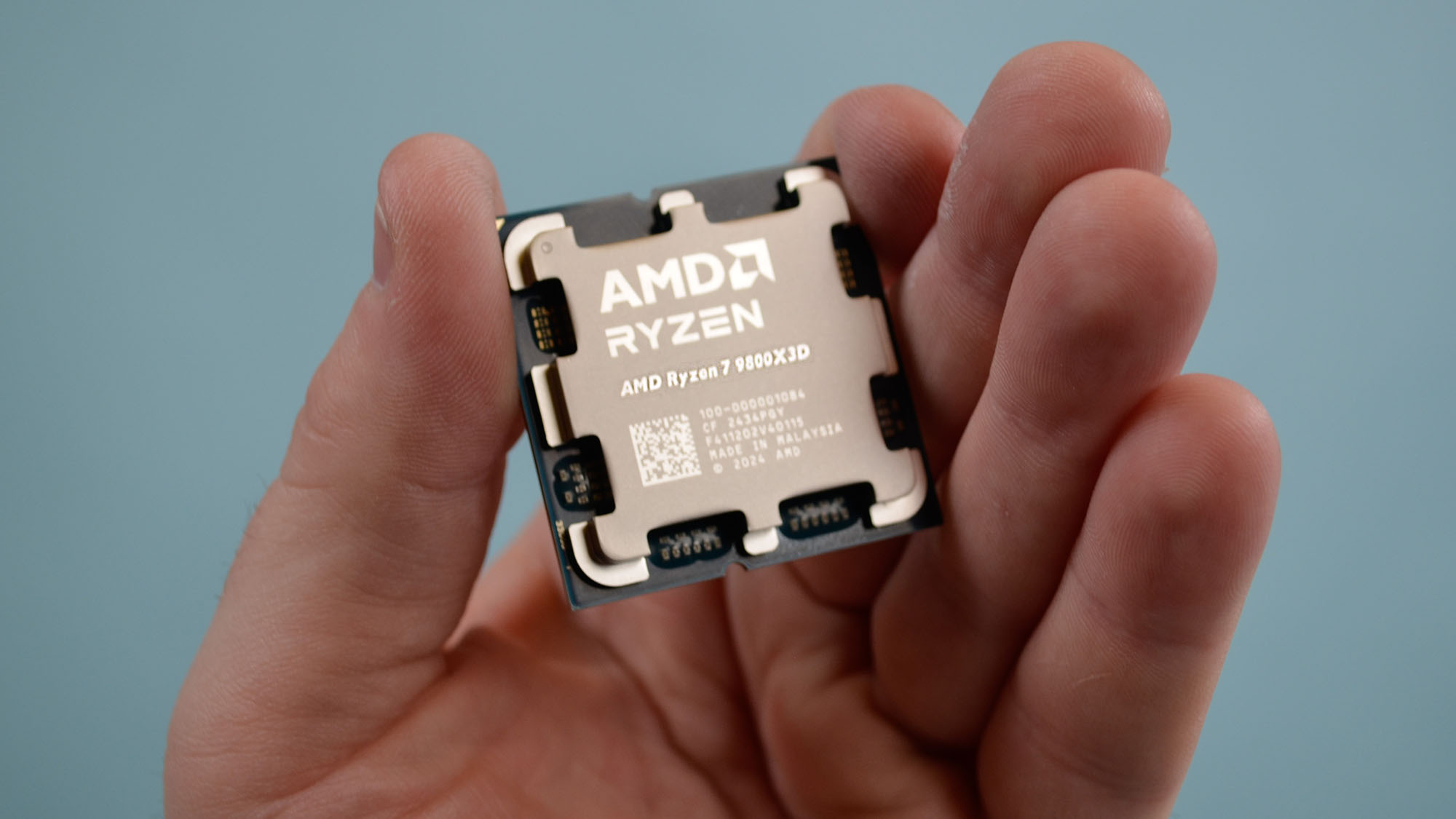 Erkeksi bir elin elinde AMD Ryzen 7 9800X3D