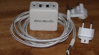 AVerMedia Elite Go GC313 Pro şarj ünitesi ve beyaz renkli yakalama kartı kombinasyonu.