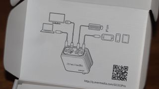 AVerMedia Elite Go GC313 Pro şarj ünitesi ve beyaz renkli yakalama kartı kombinasyonu.