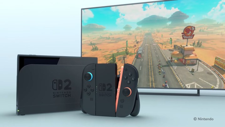 Switch 2, Mario Kart'lı bir TV'nin yanında.