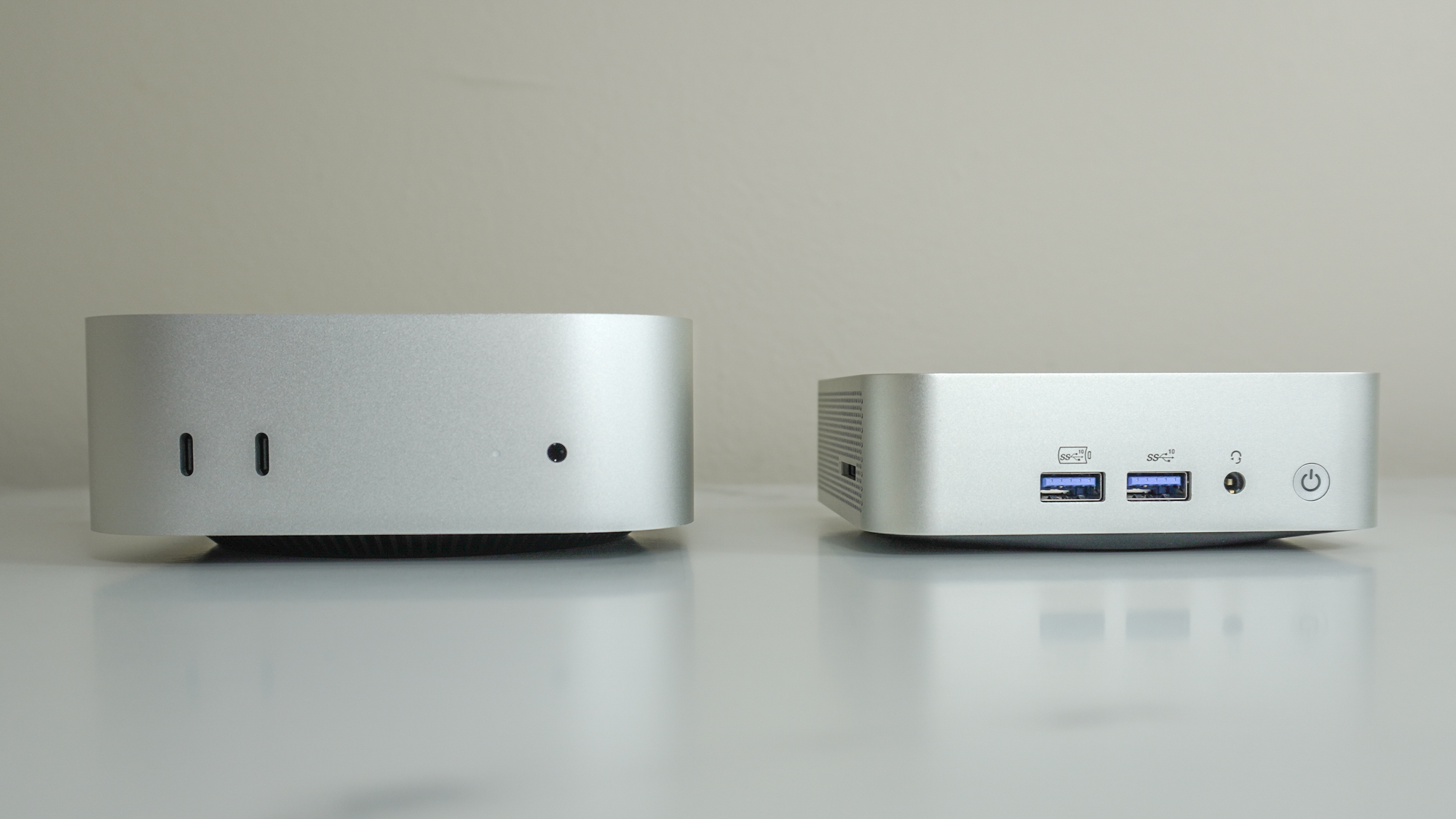 Mac Mini M4'ün yanındaki Geekom A6, her iki cihazın ön bağlantı noktalarını gösteren