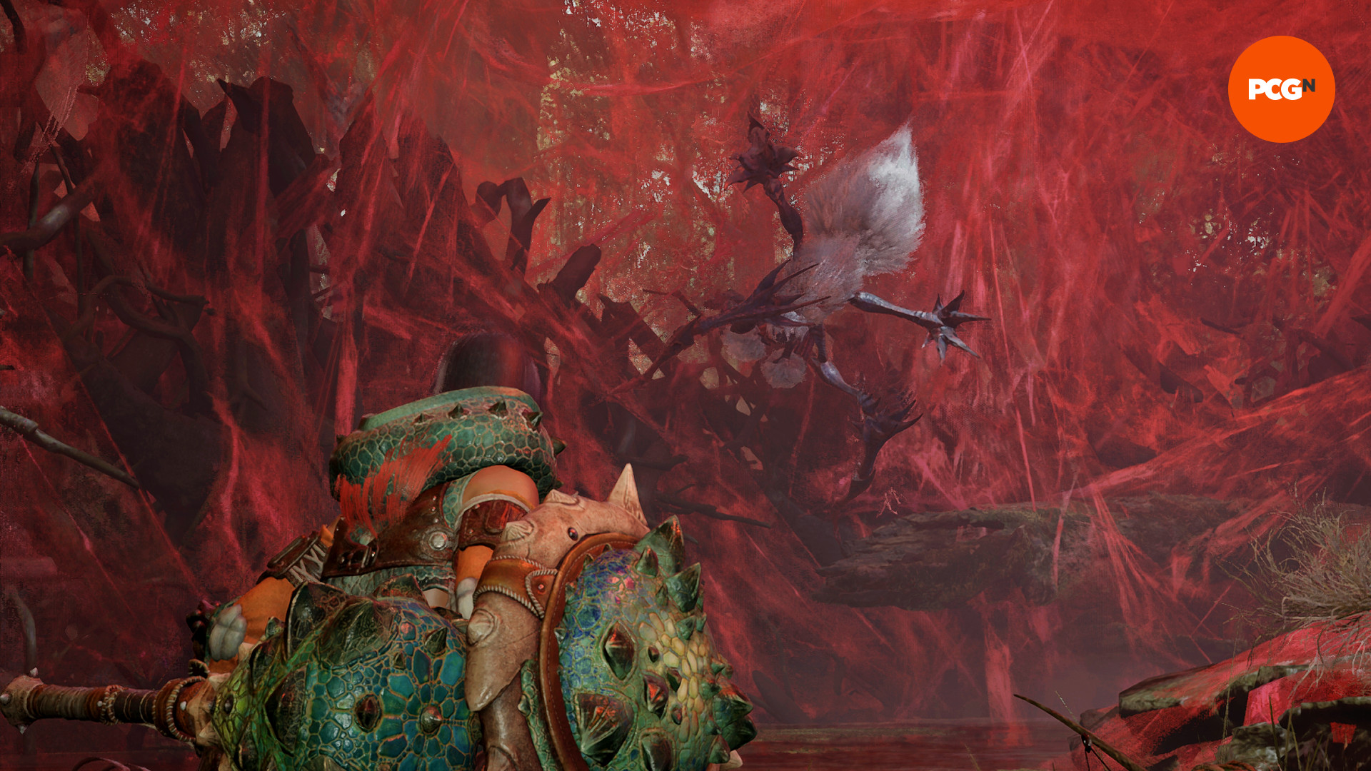 Monster Hunter Wilds - Chatacabra dişlisindeki bir avcı, yuvasındaki bir Lala Barina'ya bakar.