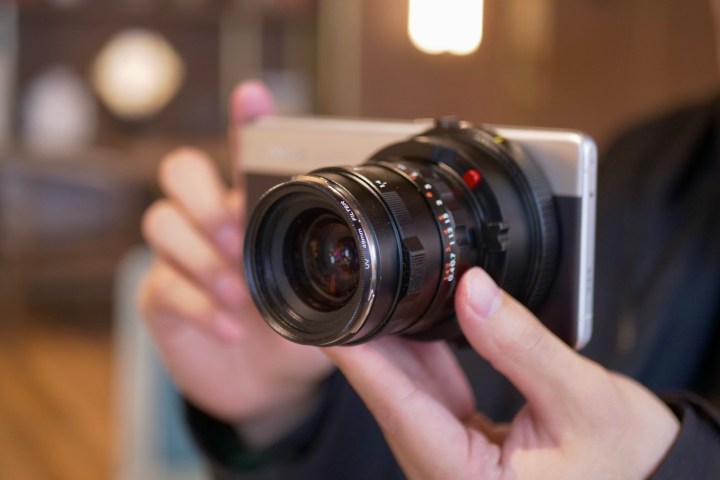 3x lens ile alan ultra konsept telefonunu tutan bir kişi.