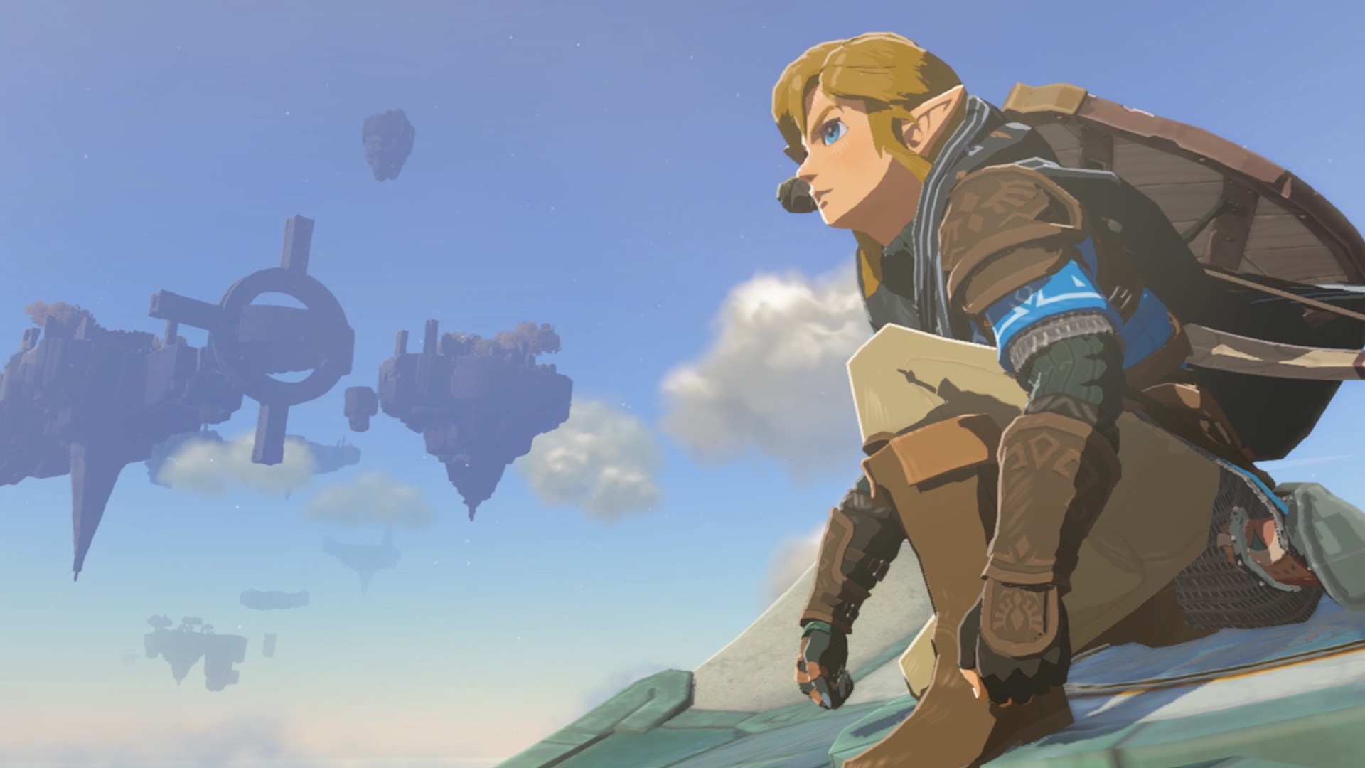 Hyrule'a bakarak çömelirler. Arka planda yüzen bir gökyüzü adası görülebilir
