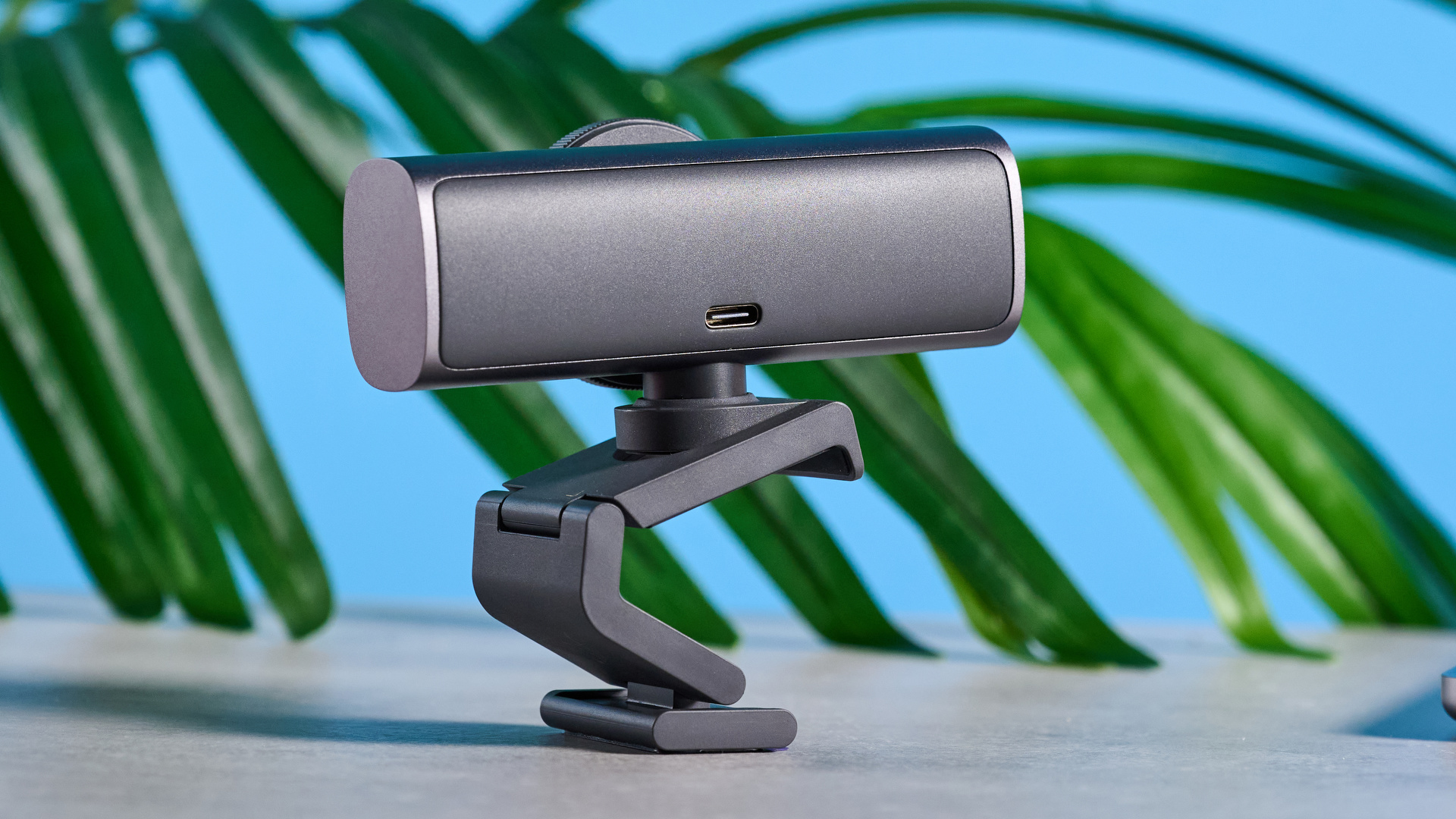 Mavi arka planın önünde resmedilen Logitech MX Brio 705