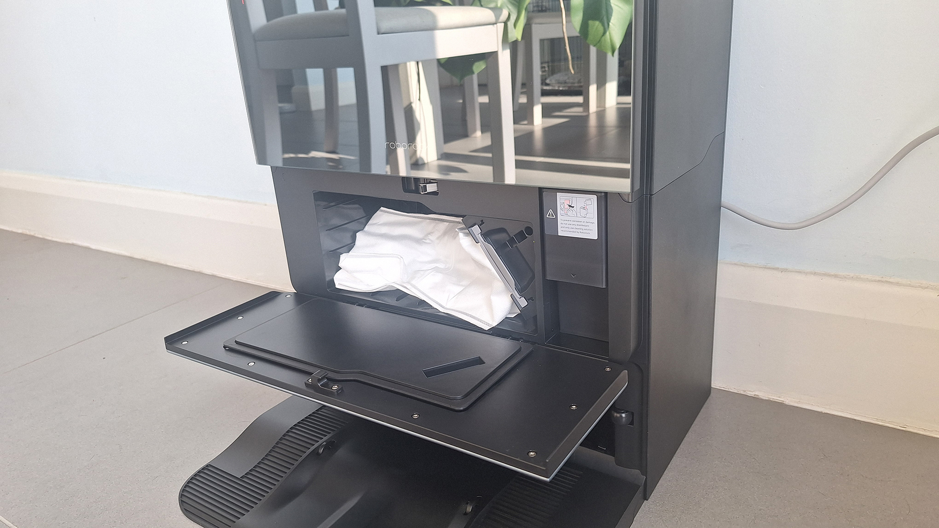Roborock Saros 10 dock with front door open to show dust bag